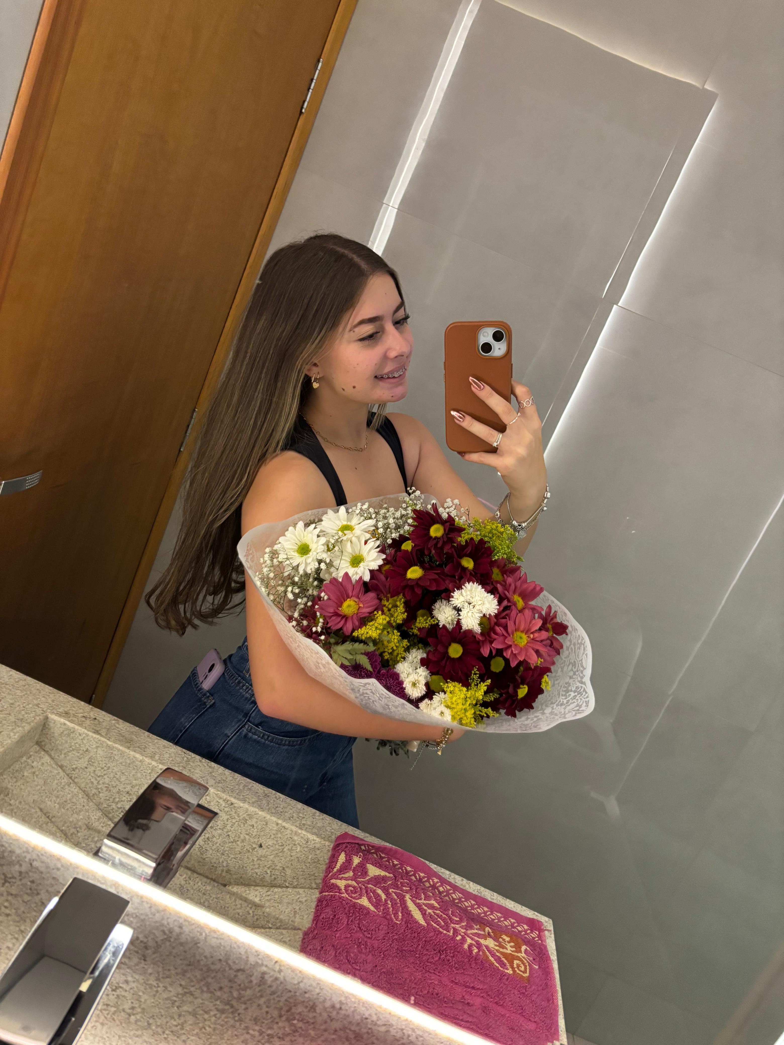 Ela sorrindo com um buquê de flores